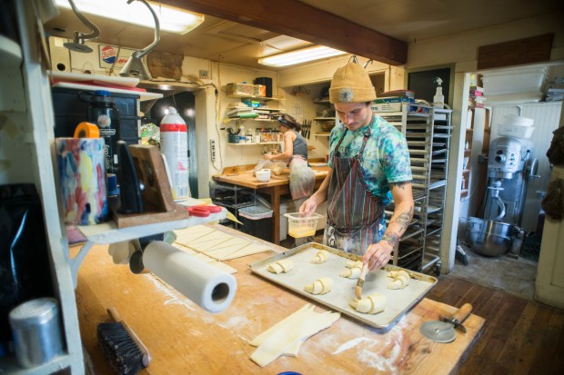 Jon Berdanier puts the finishing touches on a batch of almond maple croissants at the Polebridge Mercantile in Polebridge.