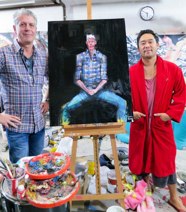 Bourdain posing with David Choe.