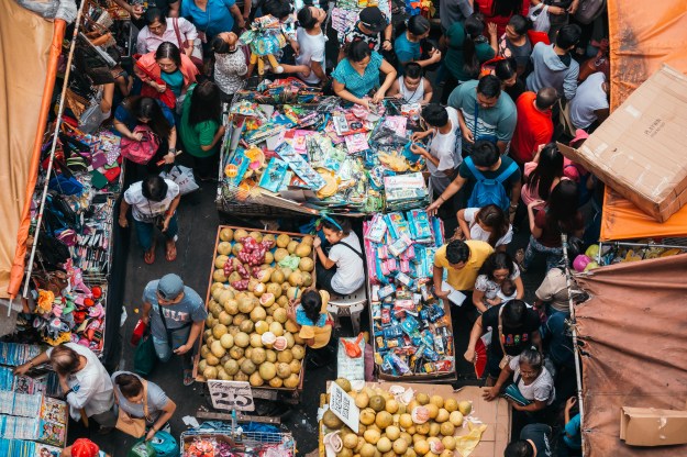 1. Quiapo street markets sell toys, clothes, and fruits during the holiday season. / 2. People buy Chinese ham at the famous "Excelente" store on Christmas eve.