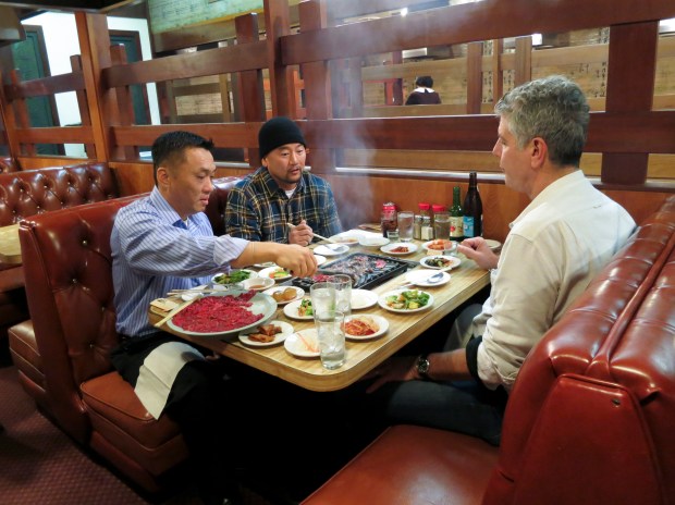 Anthony Bourdain, Roy Kim, and Roy Choi eating bulgogi and banchan at Dong Il Jang.