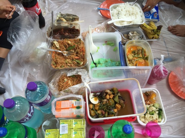 The lunch spread, including pancit noodles, chicken adobo, pinakbet stew, and buko pandan dessert.