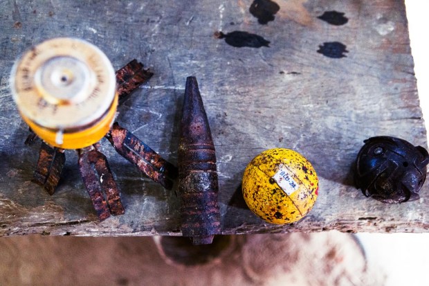 Various types of UXO present in Laos displayed on a table during a Mine Risk Education session in Lath, Laos.