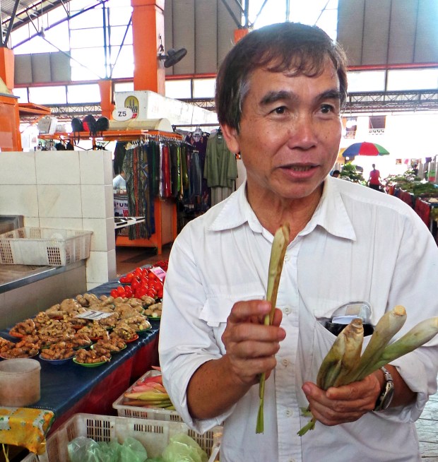 Joseph Daniel shopping in Satok Market. (Photo by Mark Hay)