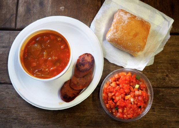 Portuguese sausage, or linguiça, now commonly replaces bacon as breakfast meat. It's served here with malasada and lomi-lomi salmon.