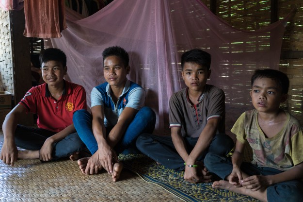 1. A group photo of the boys who were injured: Luu, Ty, Ming, and Mae. / 2. Luu shows the scars on his abdomen caused by the cluster bomb explosion.