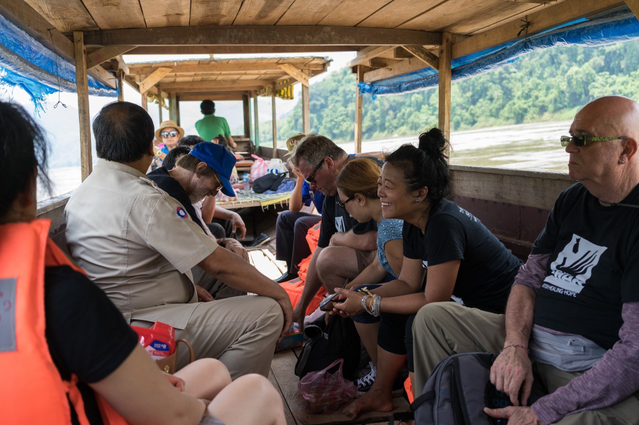 Channapha Khamvongsa and a delegation from Legacies of War on the boat to visit the village of Ban Houay Khey.