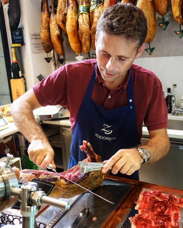 At Zapore Jai, Sylvain Faucoud serves Bourdain the finest Iberian ham in the region.