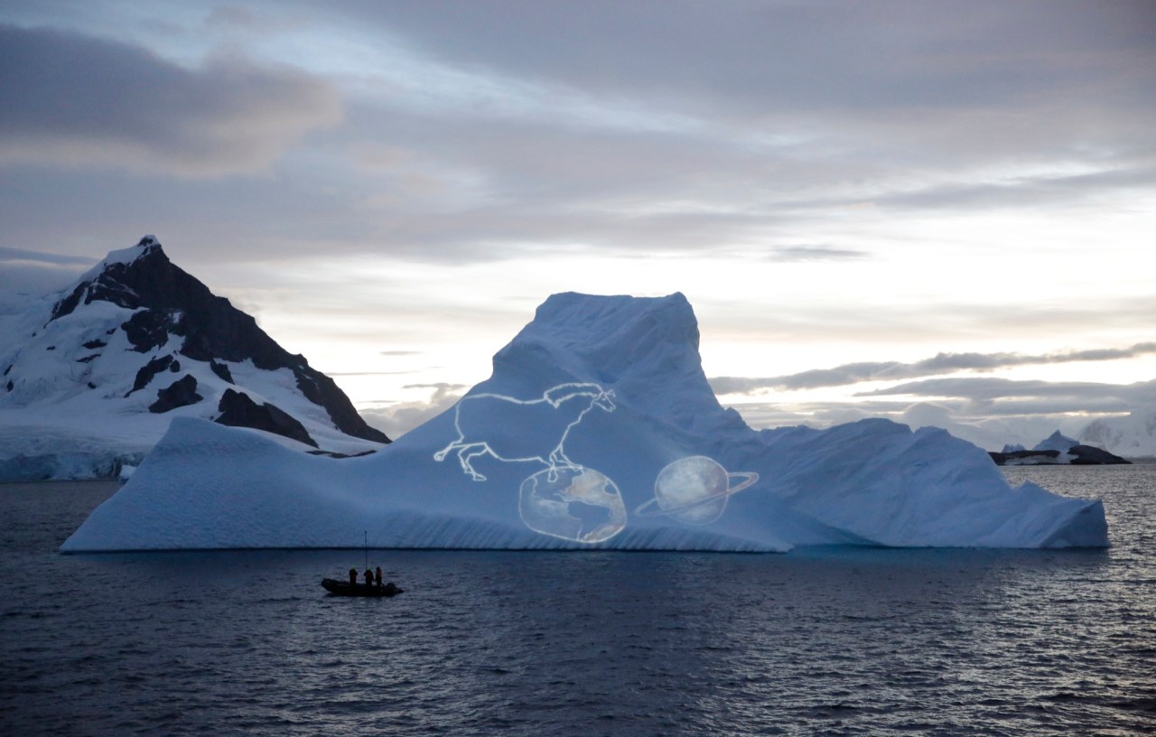 Video artist Alexis Anastasiou projected sketches of ancient rock paintings found in his native Brazil onto a towering iceberg.