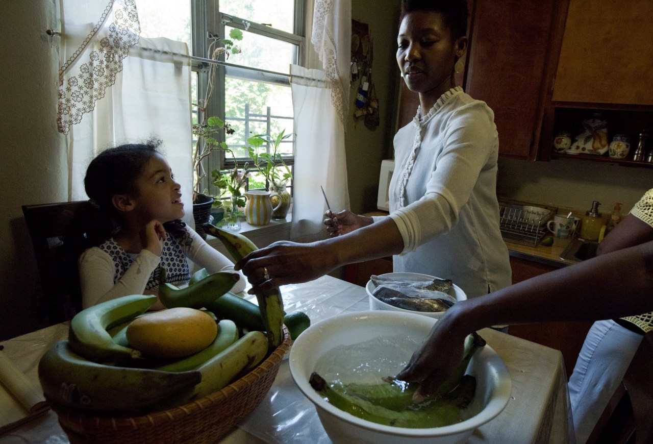 Sara Martinez’s daughter, Isha Sumner, prepares the plantains.