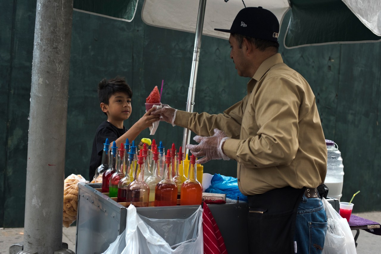 Juan serves a young customer in Corona, Queens.