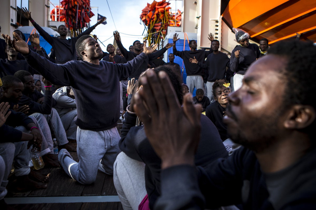 West Africans celebrate as they reach Sicily.