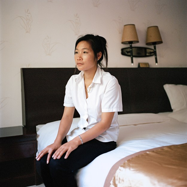 1. Hotel operator Wei Qixing, from Fujian in China, owns a hotel in the Golden City. Once a brisk business, his hotel is now vacant except for him and two of his employees. / 2. Miss Liang, a 22 year old from Luang Prabang, is one of the 12 housekeepers remaining in the Golden City Casino Hotel. At its peak, the hotel had 100 housekeepers, mostly from China.