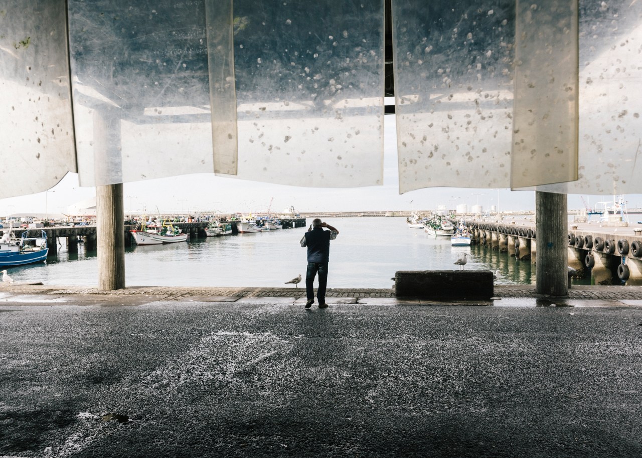 A buyer speaks on the phone with a customer during the early morning auction at the Matosinhos harbor.