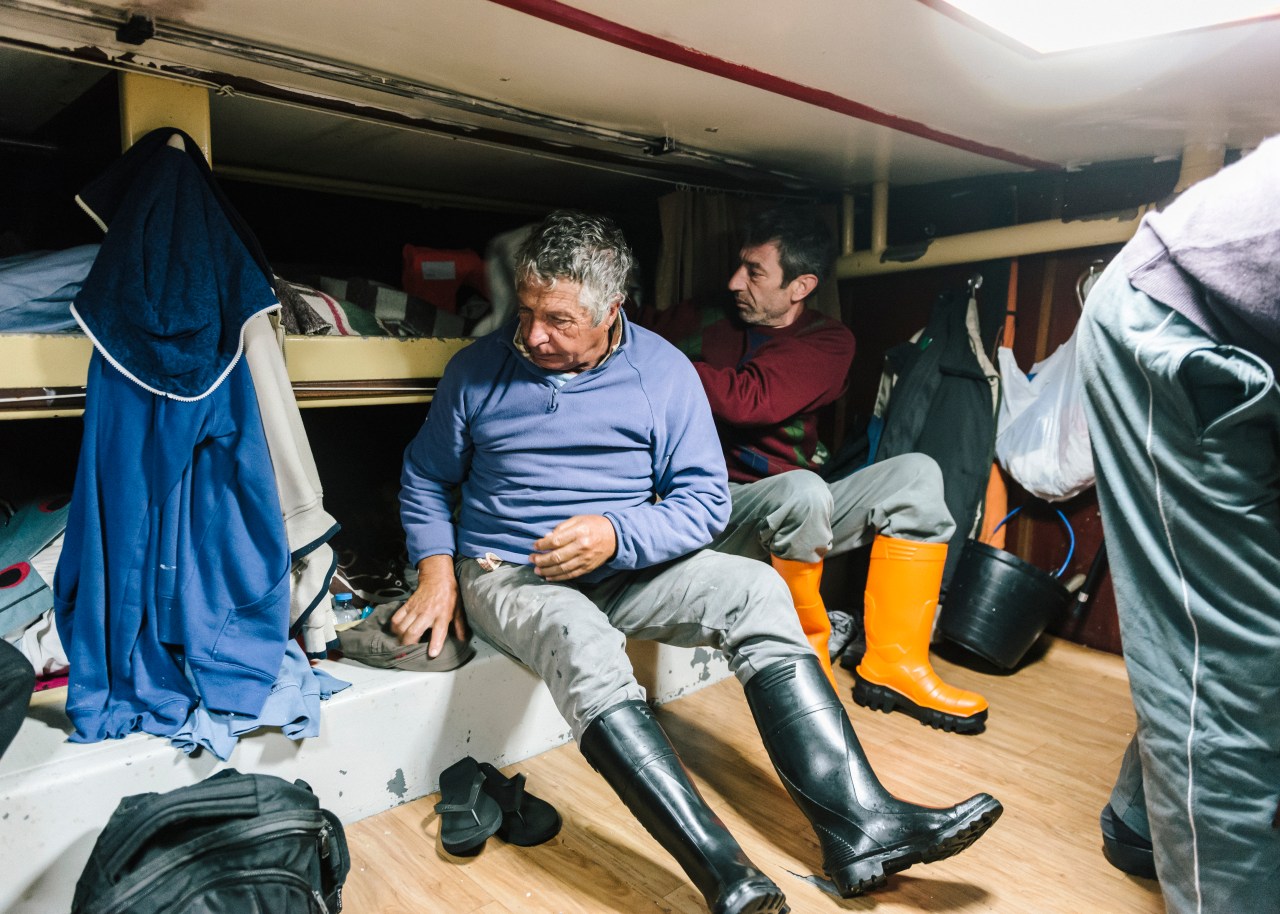 Around 3 a.m., the crew aboard the Abraão Miguel gets ready for work.