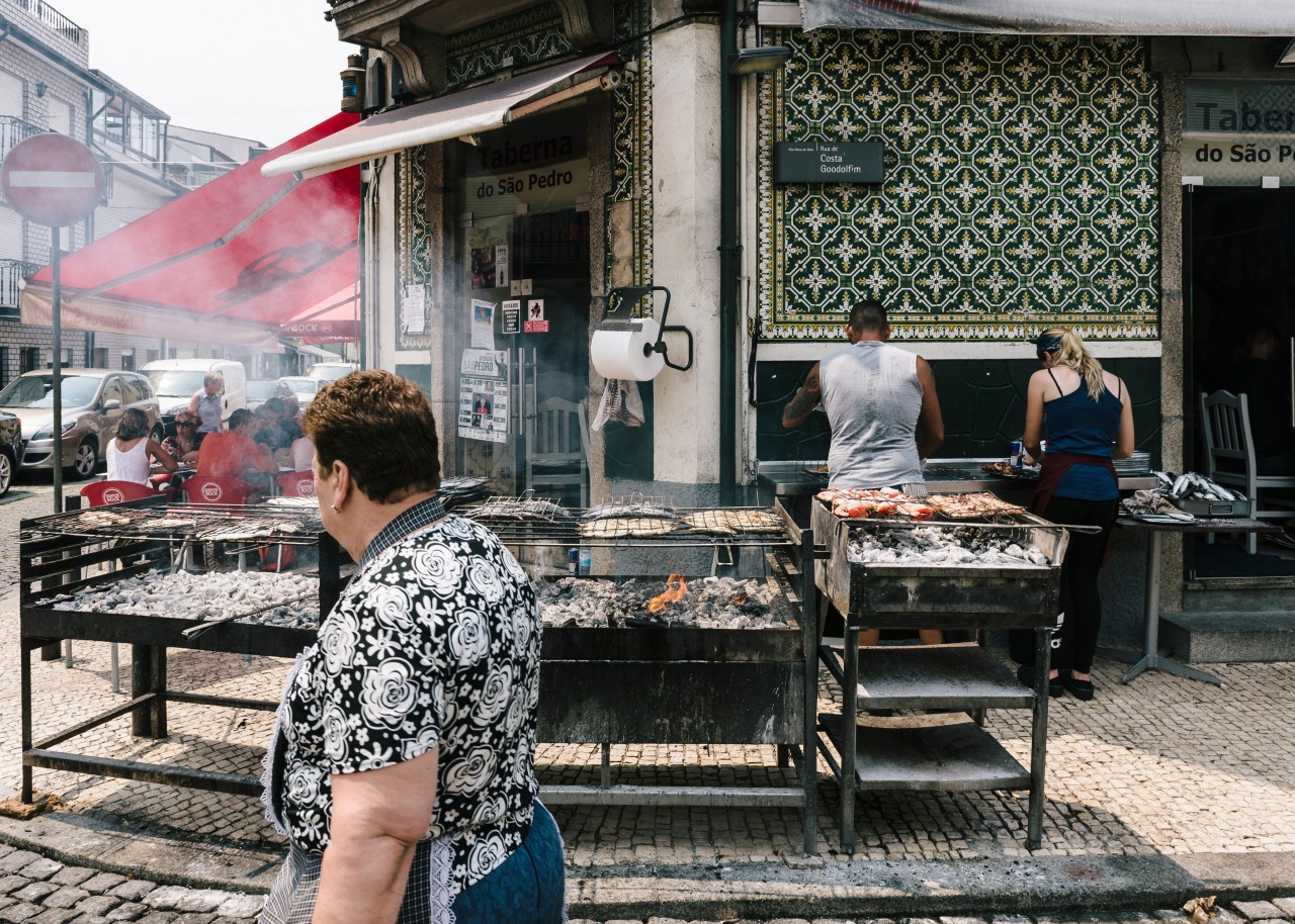 Grilling fish for lunch in the village of Afurada, located across the Douro river from Porto.