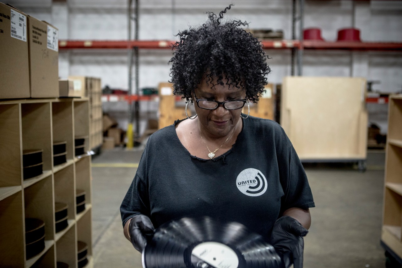 Janice Jones, an inspector, studies the vinyl before sliding it into its sleeve for packaging and shipping.