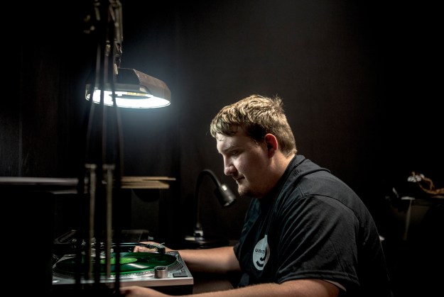 1. Wes Garland inspects a record. / 2. Jacob Moon, a quality control employee, watches and listens to a spinning record. Every 50th record is checked.