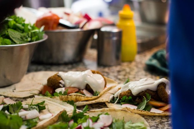 Sahyoun's sandwiches are made with six ingredients: falafel, parsley, radish, tomato, and a garlic tahini sauce called taratoor, all wrapped in thin pita bread.