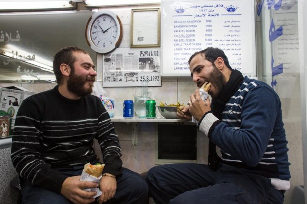 Two men chow down on Sahyoun’s falafel.