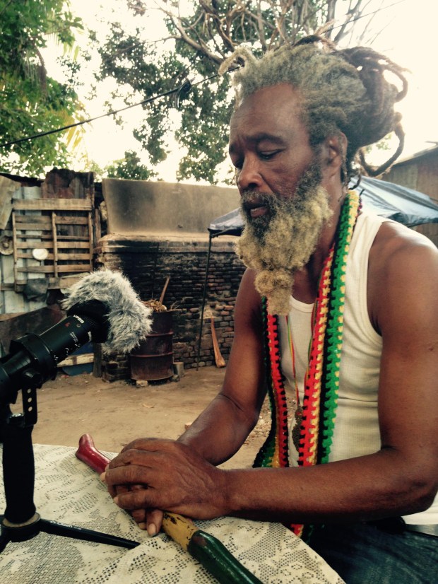Ras Ayatollah speaks with the writer in the yard at Ibo Spice in Downtown Kingston. (Photo by Saxon Baird)