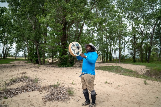 1. Days on a river expedition often begin before sunrise. / 2. Mark “River” Peoples, a river guide with the Quapaw Canoe Company, plays the hand drum during an Easter ceremony.