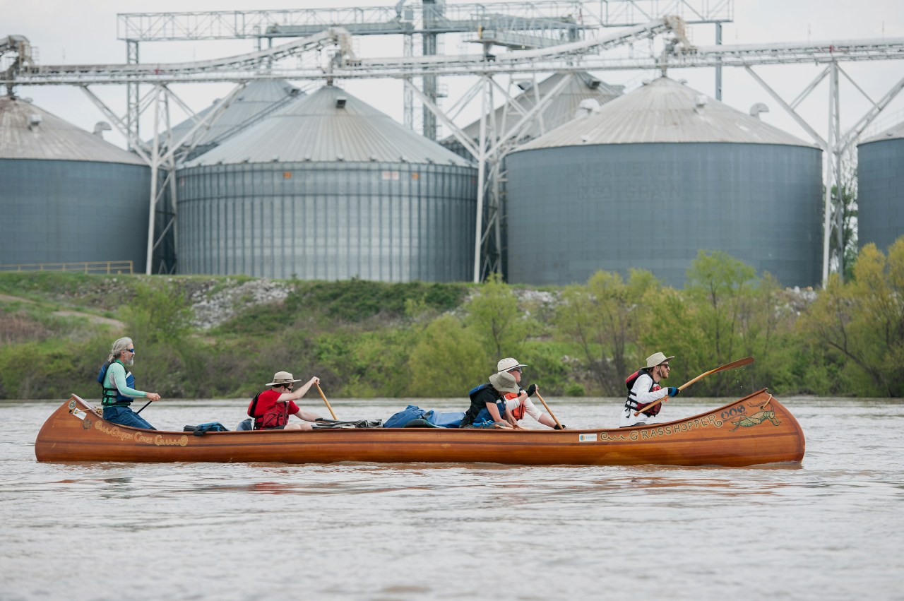 The crew—with the author in the bow and Ruskey in the stern—passes grain storage for the farms that sit alongside the river.