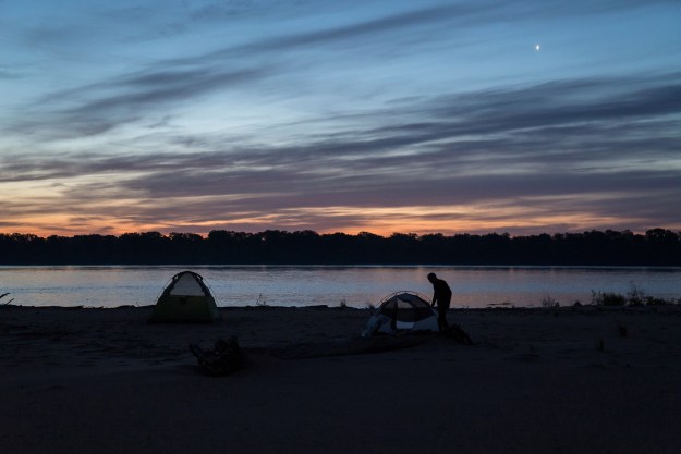 1. Days on a river expedition often begin before sunrise. / 2. Mark “River” Peoples, a river guide with the Quapaw Canoe Company, plays the hand drum during an Easter ceremony.