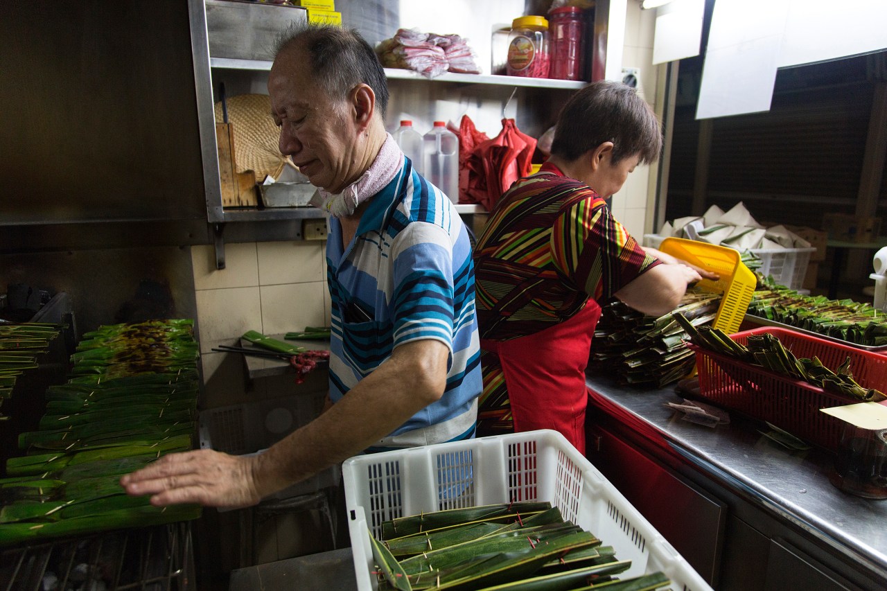 Tan Beng and Tee Ai Geok prepare otah in their stall at Old Airport Road Food Centre.