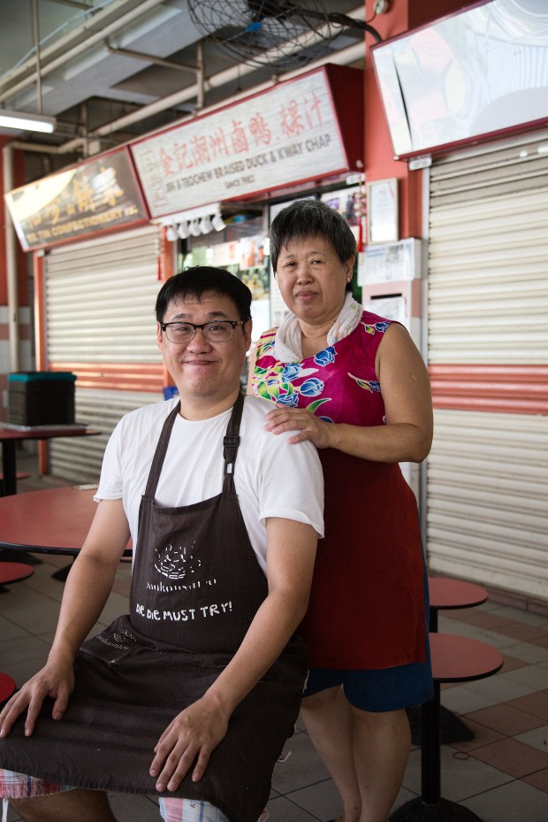 Melvin Chew and his mother pose outside of their stall.