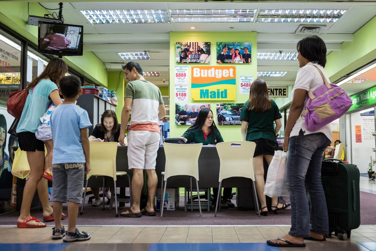 A family picks up their domestic workers at an agency in Bukit Timah shopping centre, Singapore.