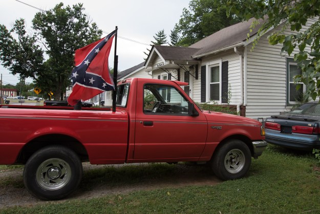 A truck parked in the driveway of a home and a yard sign in Murfreeesboro.