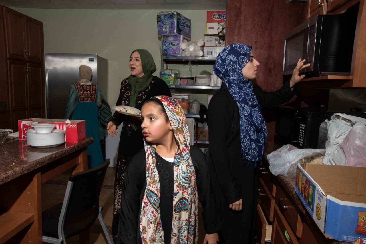 Food is served in the kitchen on an evening during Ramadan.