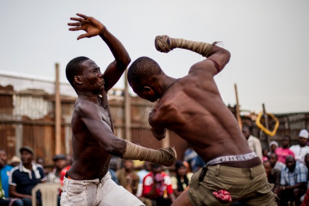 1. Hassan Abu Trassan, 22, (L) attempts to block a strike from 'Shago' Abatamai Chikba, 21, (R) during a match in Lagos. / 2. Autan Sikido, 27, originally from Kaduna State, prepares to strike during a match.