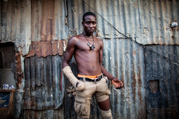 1. Hassan Abu Trassan, 22, is from Niamey in Niger. He began boxing to seek fame and fortune. / 2. Dambe boxer 'Shago' Rikishi, 25, poses for a portrait in Lagos.