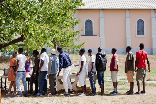 1. Daily lunch distribution by volunteers at the parish of Briançon. / 2. An asylum seeker.