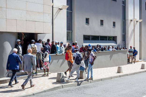 1. Migrants get some rest after their long journey from Italy to the emergency shelter of Briançon. / 2. Unaccompanied minors line up at the Regional Council of Hautes-Alpes in the city of Gap for public assistance.