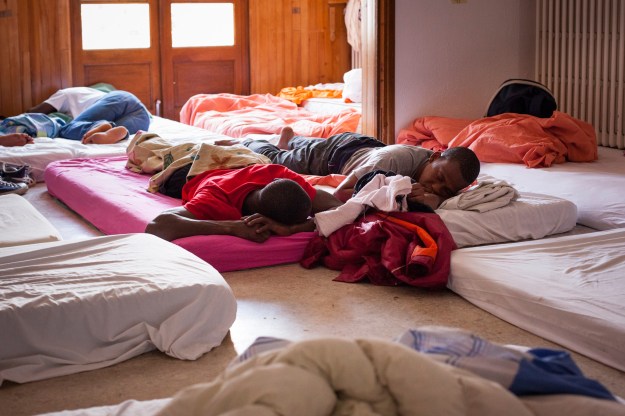 1. Migrants get some rest after their long journey from Italy to the emergency shelter of Briançon. / 2. Unaccompanied minors line up at the Regional Council of Hautes-Alpes in the city of Gap for public assistance.