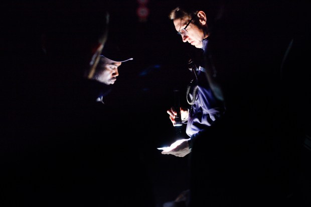 A policeman checks the identification papers of a migrant who was apprehended on the road to the Échelle mountain pass.