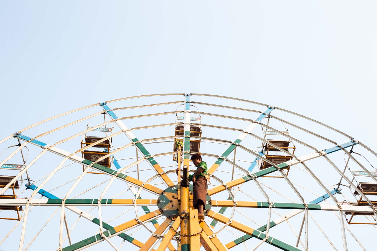 A Ferris wheel operator at Shwe San Daw Pagoda festival in the Twantay township, on the outskirts of Yangon.