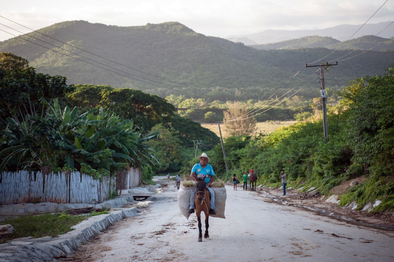 A cowboy makes his way uphill into Trinidad, a town in central Cuba.