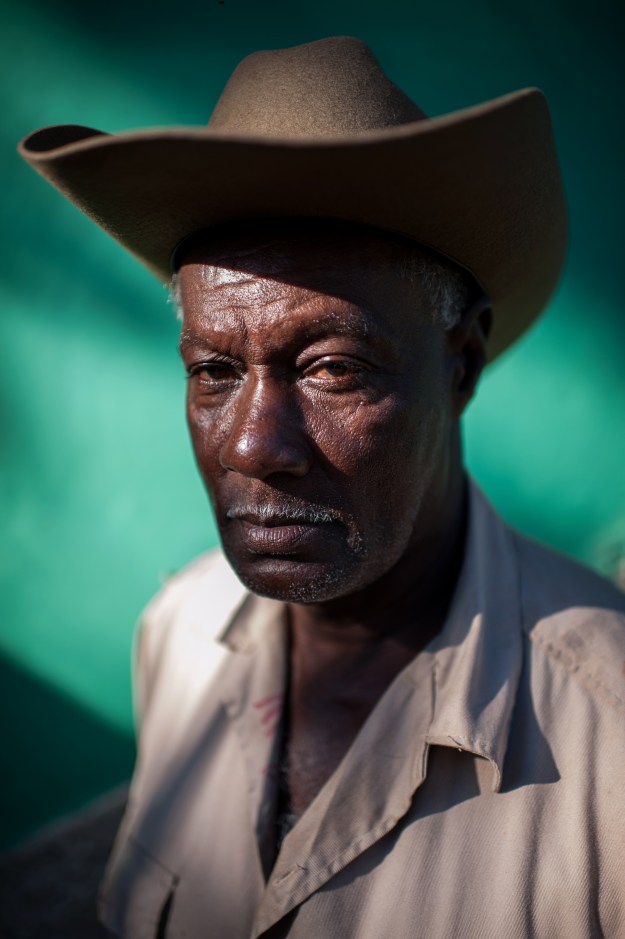 1. A cowboy from Viñales poses for a portrait while having his morning coffee, rum, and cigar. / 2. Ismael Gavilan, a cowboy and pig farmer living in Viñales.