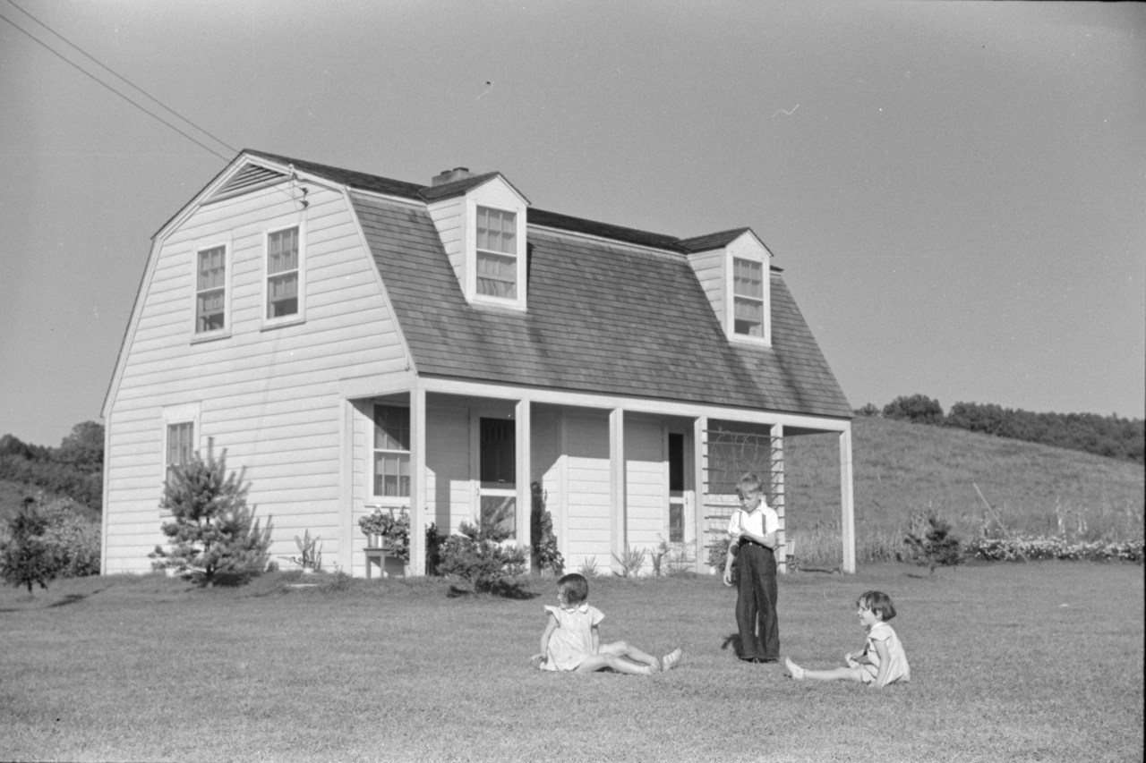Children of homesteaders play on their front lawn in Tygart Valley, September 1938. As part of the New Deal, the federal government built three homestead communities in West Virginia. The program provided employment opportunities, farmland, and modern, affordable housing for some 25,000 families. Photo by Marion Post Wolcott.