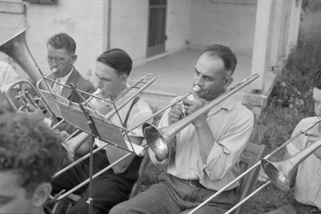 Photo 1: Two boys watch a puppet show in Red House, 1937. Photo 2: A band rehearses outdoors in Red House, 1937. Photos by Ben Shahn.