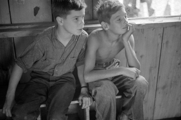 Photo 1: Two boys watch a puppet show in Red House, 1937. Photo 2: A band rehearses outdoors in Red House, 1937. Photos by Ben Shahn.