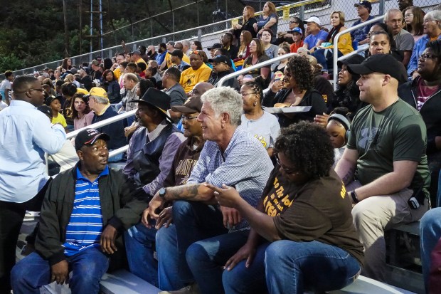 Tony takes in the Mt. View homecoming game with locals Garnet Edwards, Garnet Edwards, JR, and Monica Barner.