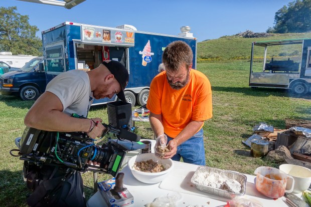 Camera operator Josh Flannigan films turtle meat cakes being prepped for the griddle at King Knob Motorsports Park.