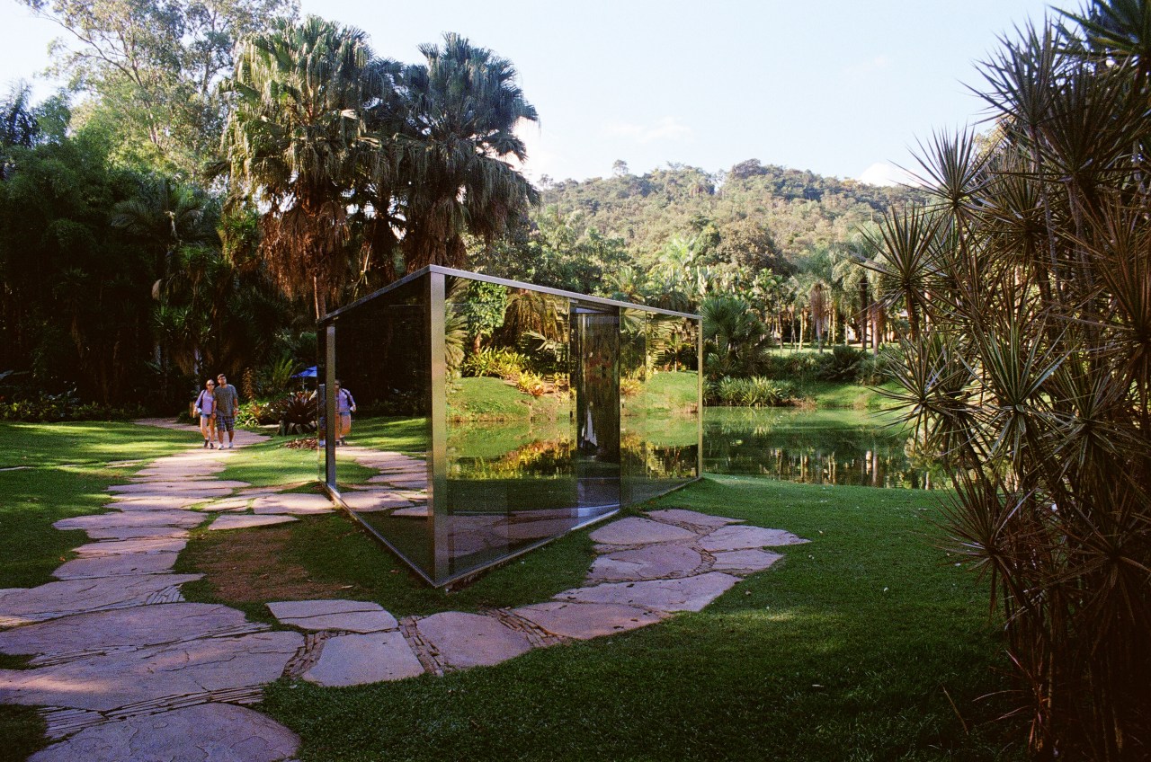 Approaching Dan Graham’s mirrored installation, “Bisected Triangle, Interior Curve.”