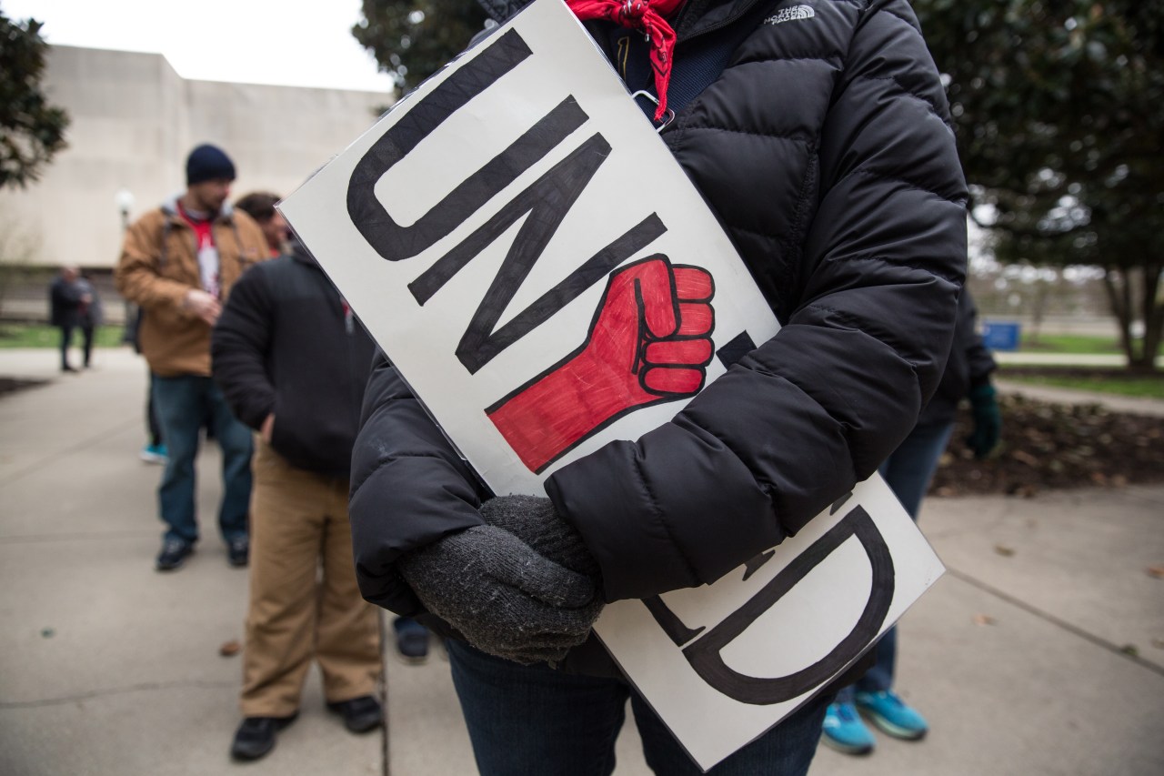 A teacher held a "United" sign during a rally outside the West Virginia Capitol in Charleston during a protest in March. Photo by Scott Heins/Bloomberg via Getty Images