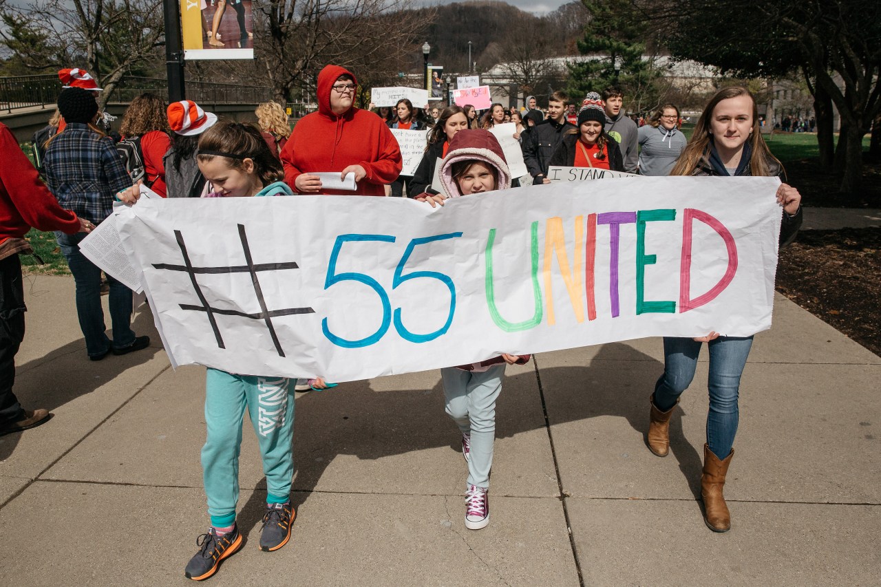 Demonstrators hold a sign reading "#55United" during the rally. Photo by Scott Heins/Bloomberg via Getty Images