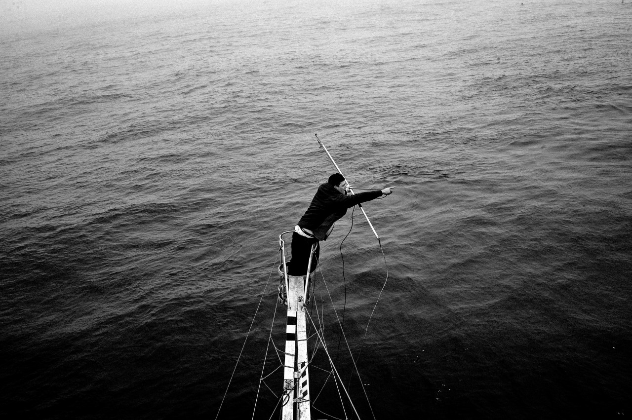 From high above the deck, Hally Henneberry points to the position of a swordfish.
